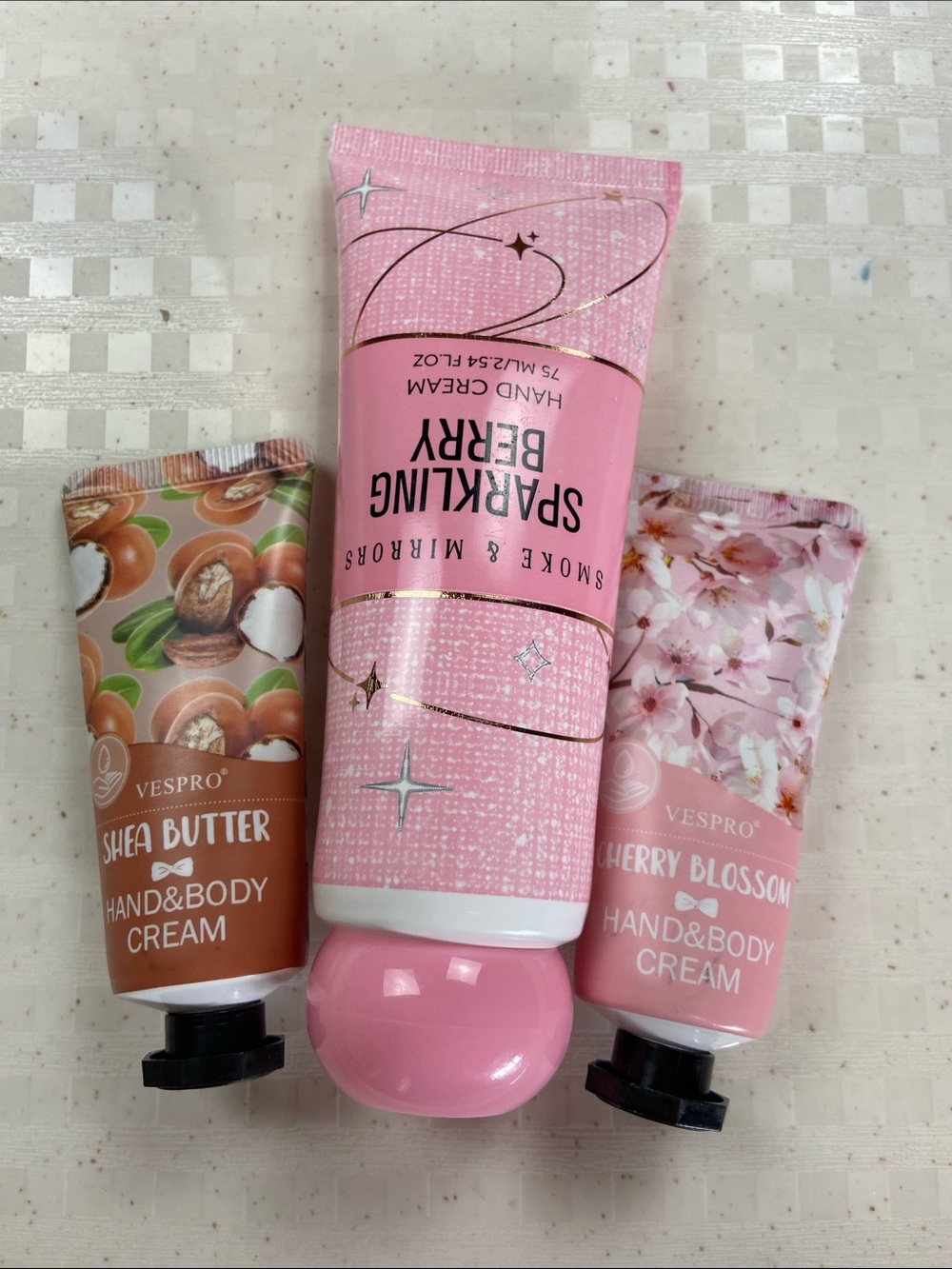 One sparkling berry lotion and two mini hand and body creams